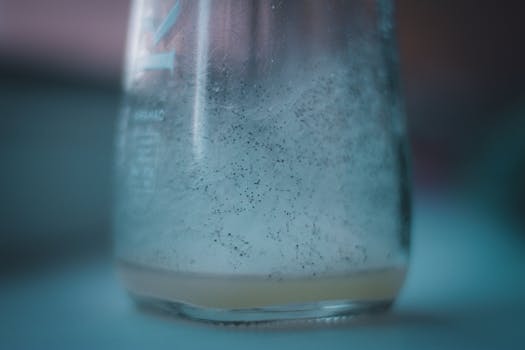 a bottle of cold medicine with a glass of water