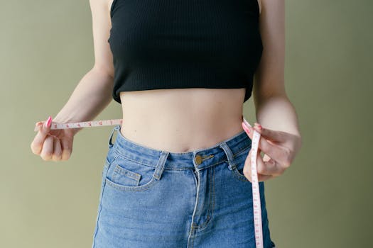 image of a woman measuring her waist